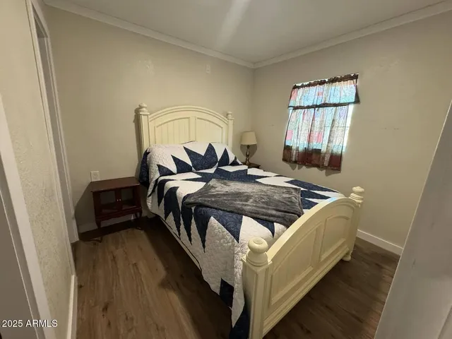 a bed sitting in a bedroom next to a window