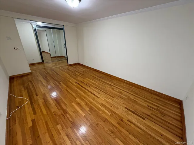 a view of a room with wooden floor
