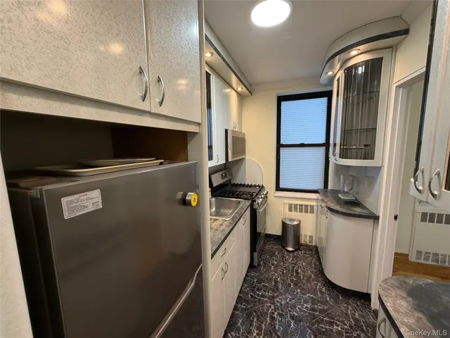 a kitchen with a refrigerator and a sink