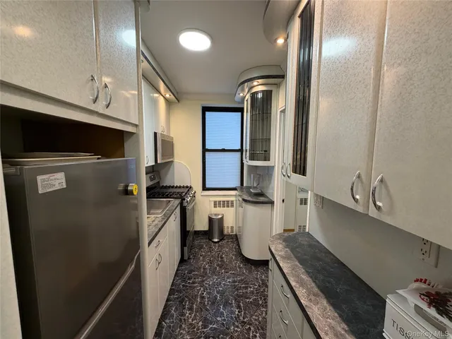 a kitchen with a sink stainless steel appliances and cabinets