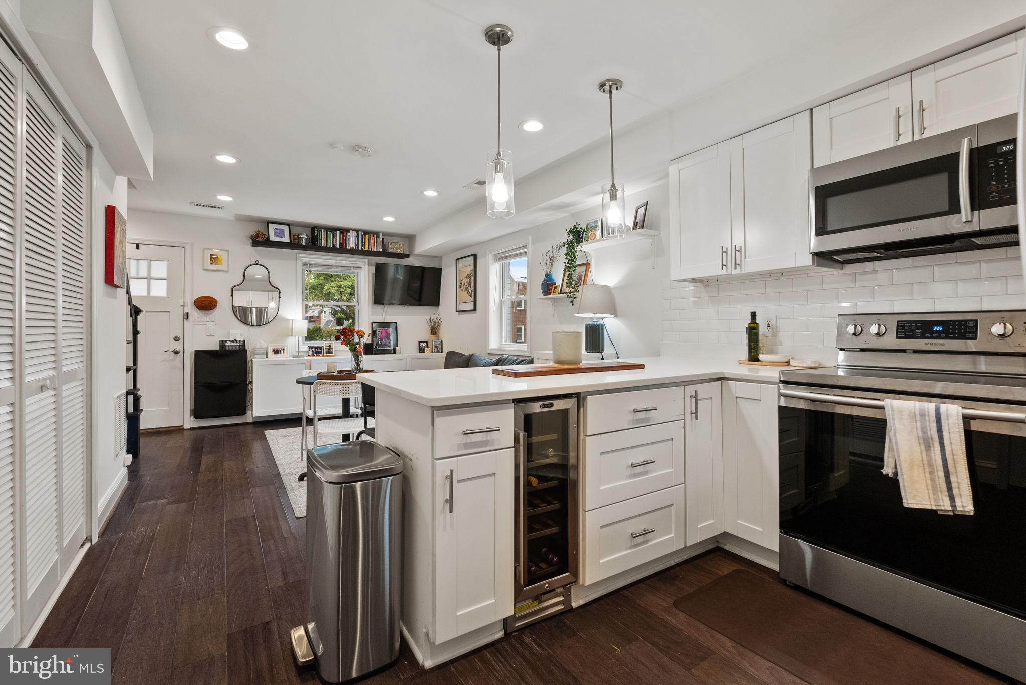 2000 East A Street Northeast Washington, DC 20002 - Photo 10 of 26 a kitchen with stainless steel appliances kitchen island granite countertop a stove a sink and a refrigerator