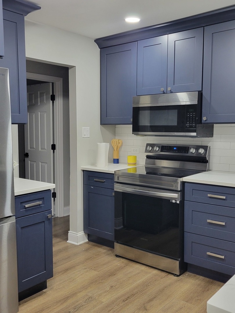 1100 Holbrook Road, Unit H Homewood, IL 60430 - Photo 6 of 13 a kitchen with granite countertop wooden cabinets and a stove top oven