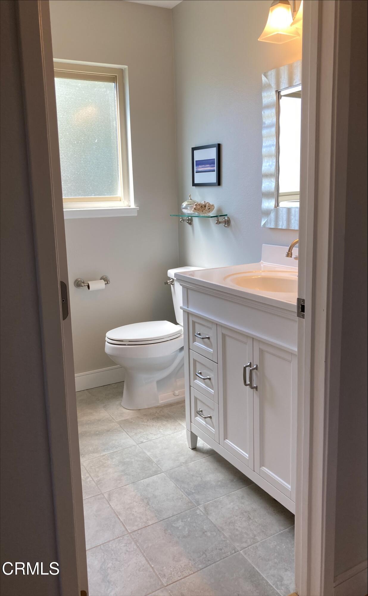 1711 Masthead Drive Oxnard, CA 93035 - Photo 15 of 28 a bathroom with a sink a toilet and a window