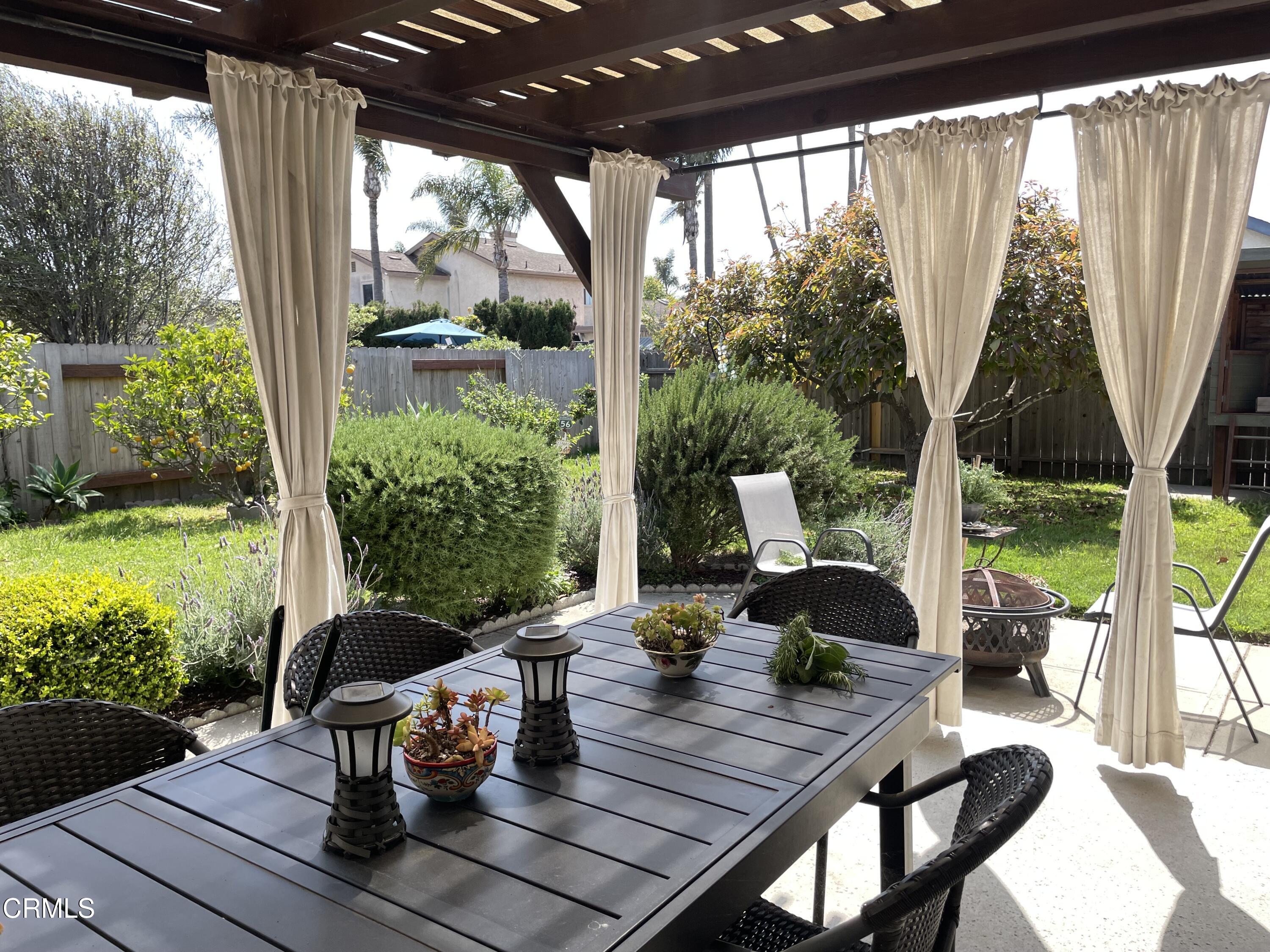 1711 Masthead Drive Oxnard, CA 93035 - Photo 16 of 28 a view of a patio with table and chairs potted plants and floor to ceiling window