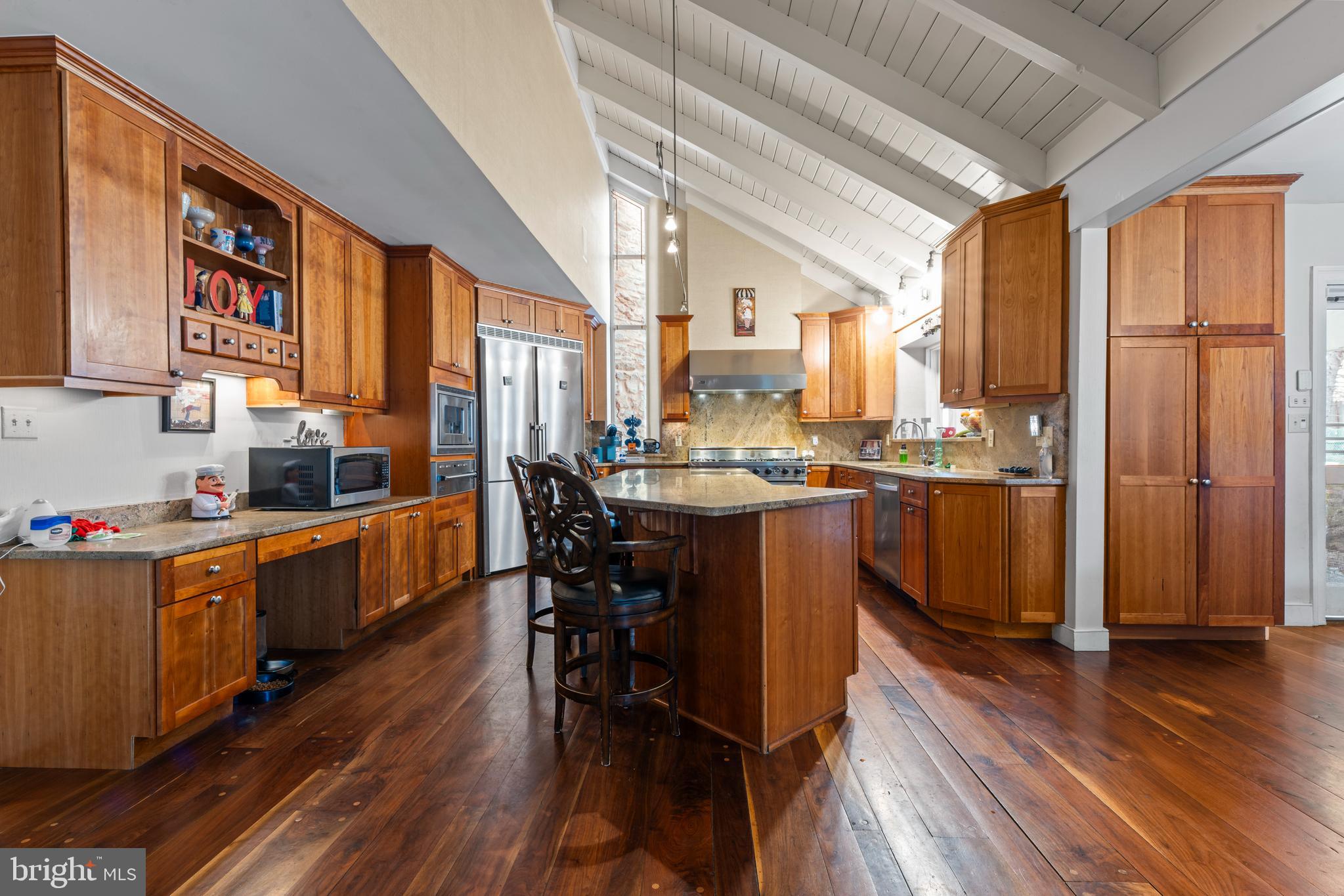 2141 Paper Mill Road Huntingdon Valley, PA 19006 - Photo 21 of 58 a kitchen with stainless steel appliances a table chairs refrigerator and sink