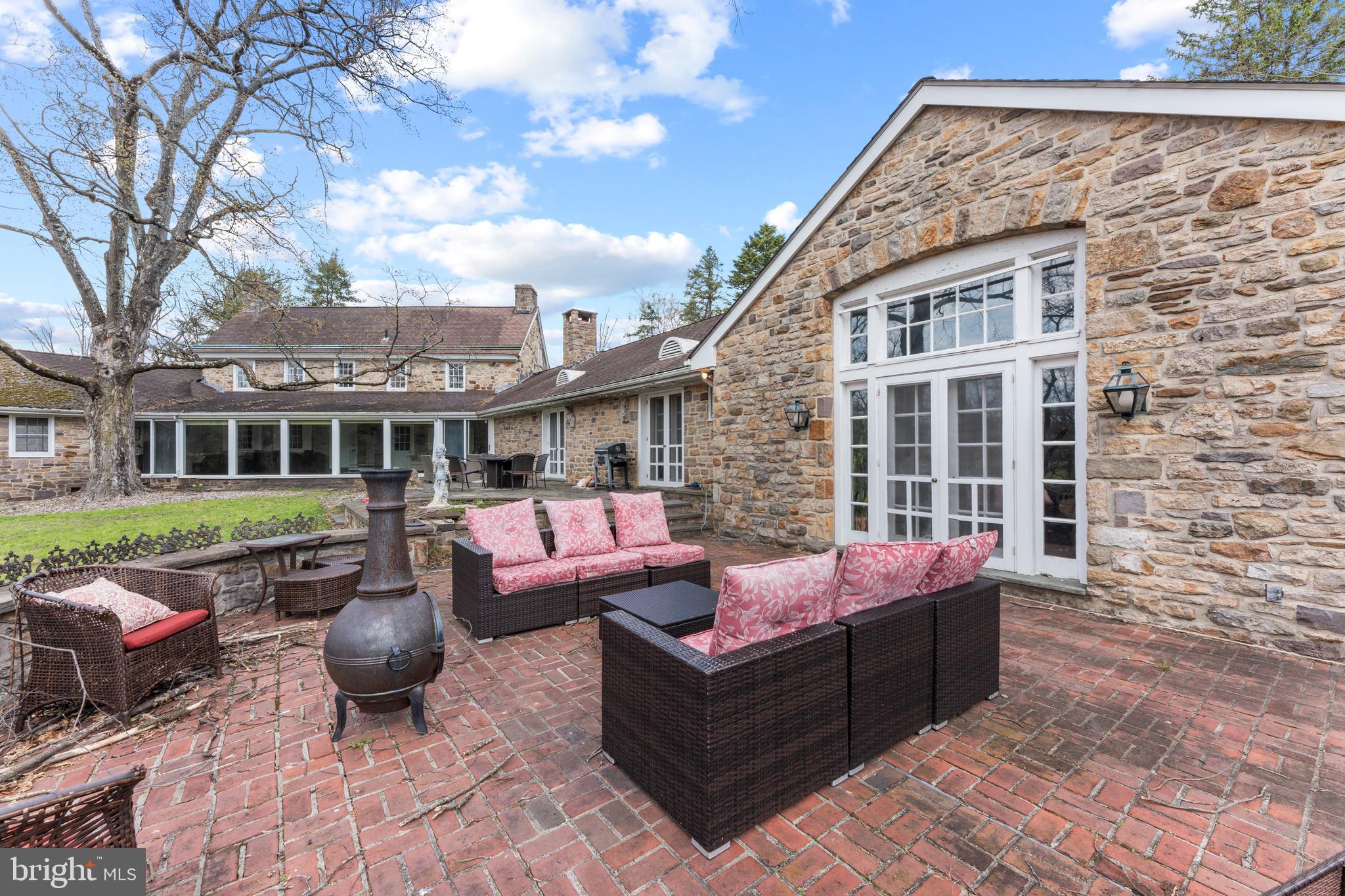 2141 Paper Mill Road Huntingdon Valley, PA 19006 - Photo 34 of 58 a view of a patio with couches chairs and a fire pit