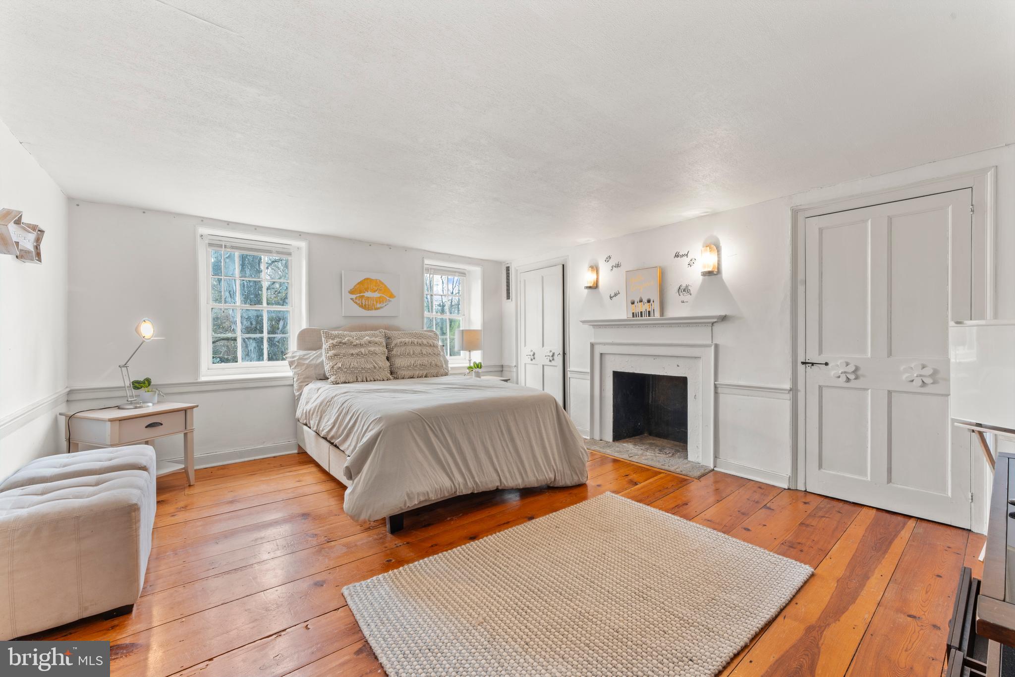 2141 Paper Mill Road Huntingdon Valley, PA 19006 - Photo 52 of 58 a bedroom with a large bed and a fireplace