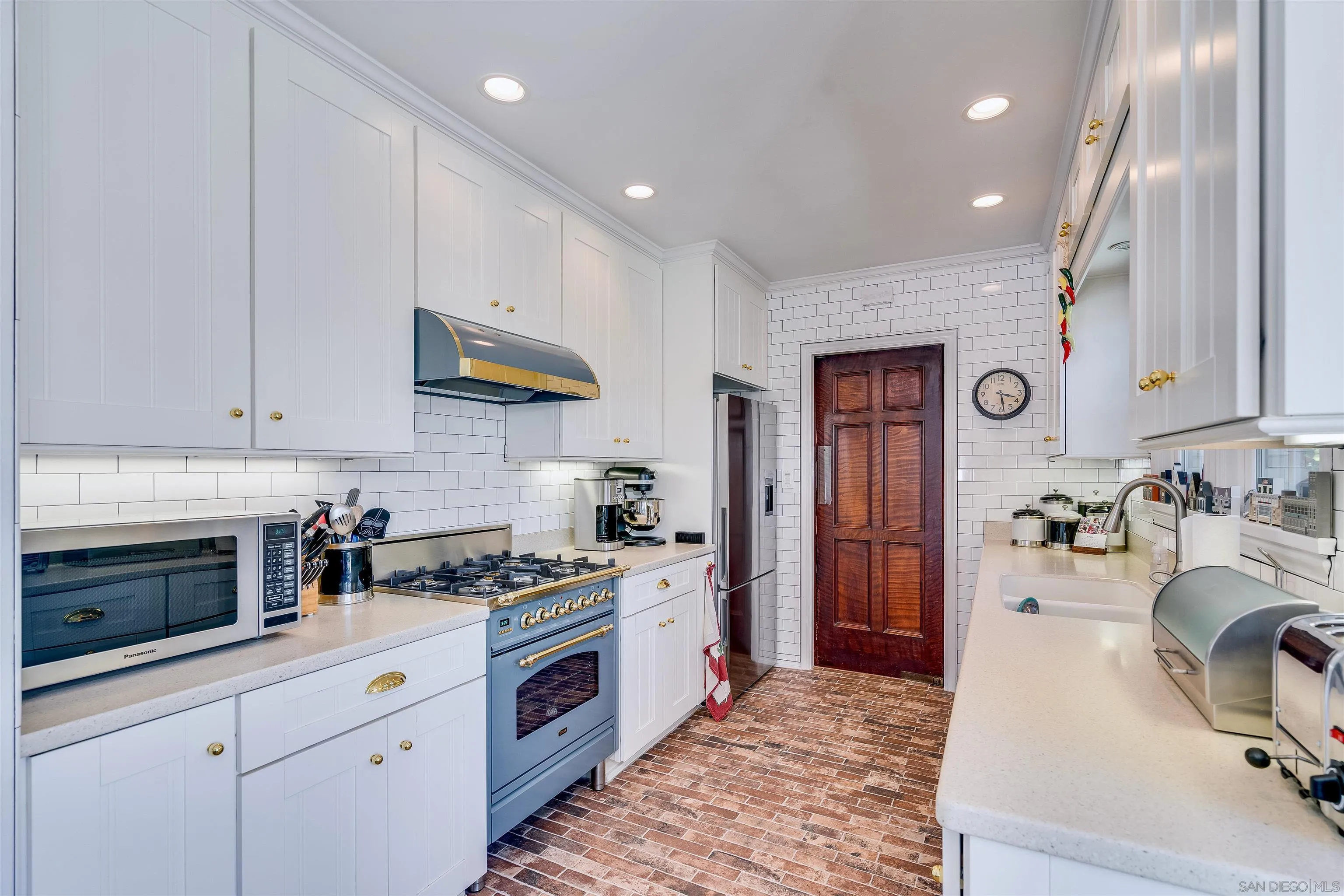 1210 Third Street Coronado, CA 92118 - Photo 11 of 40 a kitchen with stainless steel appliances granite countertop a stove and a sink