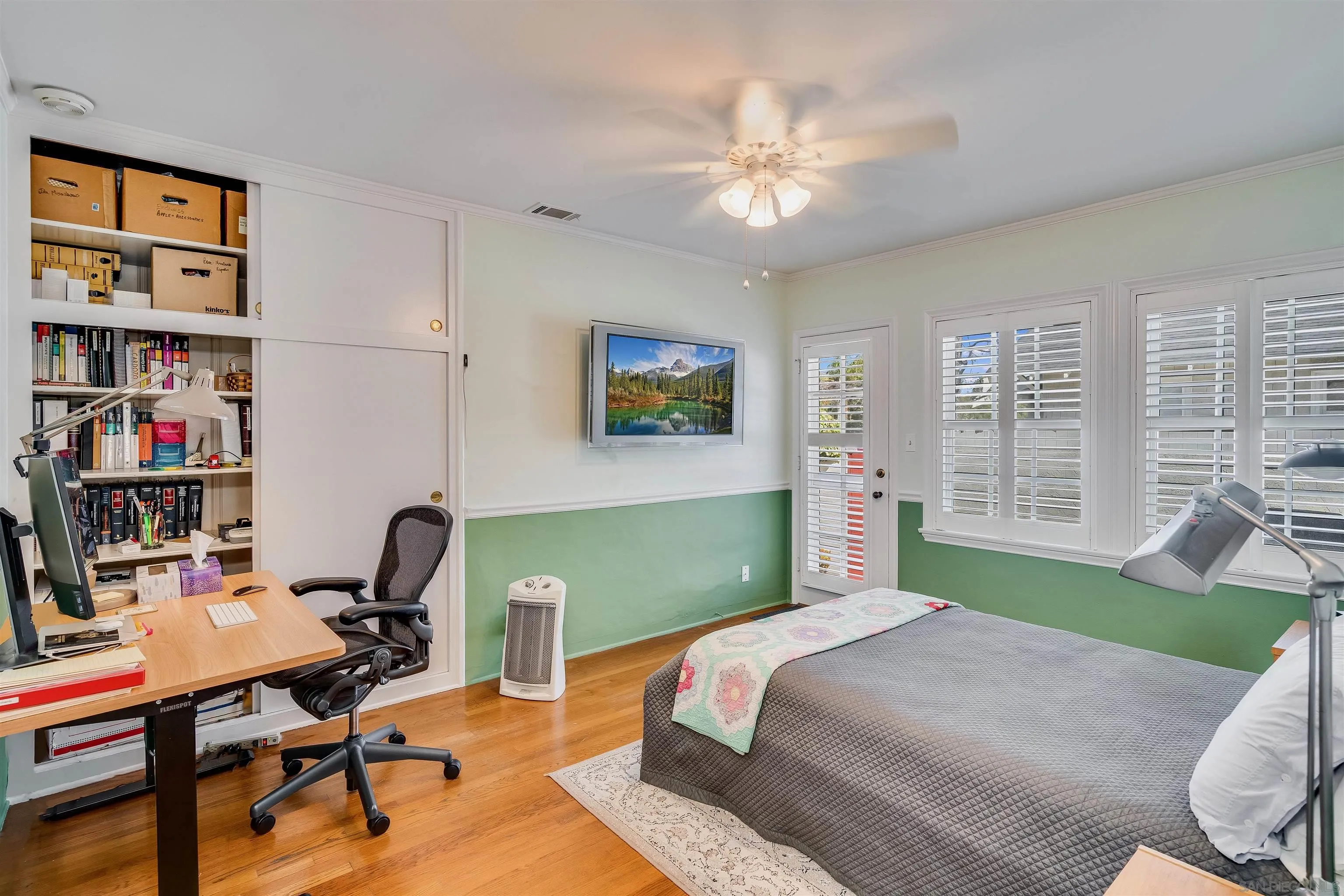 1210 Third Street Coronado, CA 92118 - Photo 18 of 40 a bedroom with a bed a desk and book shelfs