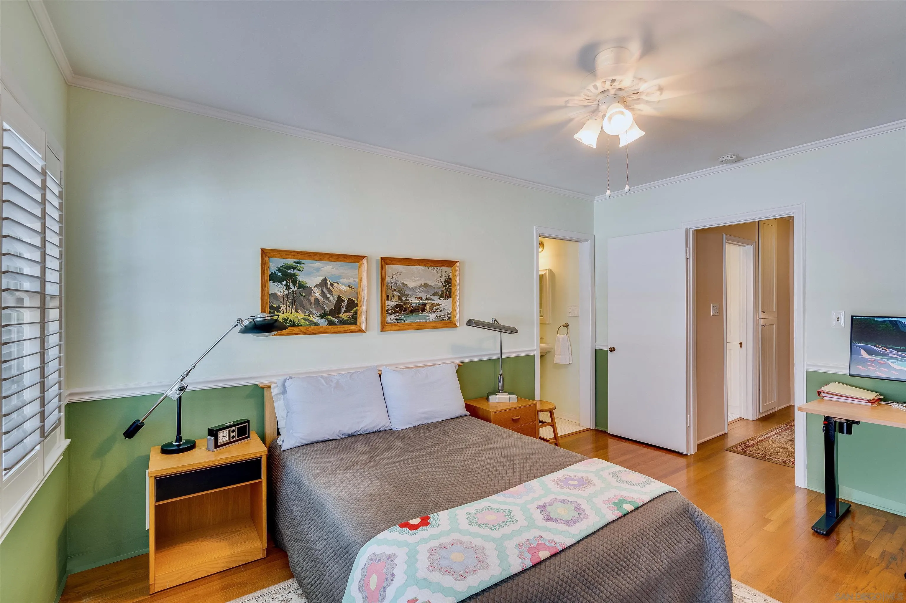 1210 Third Street Coronado, CA 92118 - Photo 19 of 40 a bedroom with a bed and a chandelier