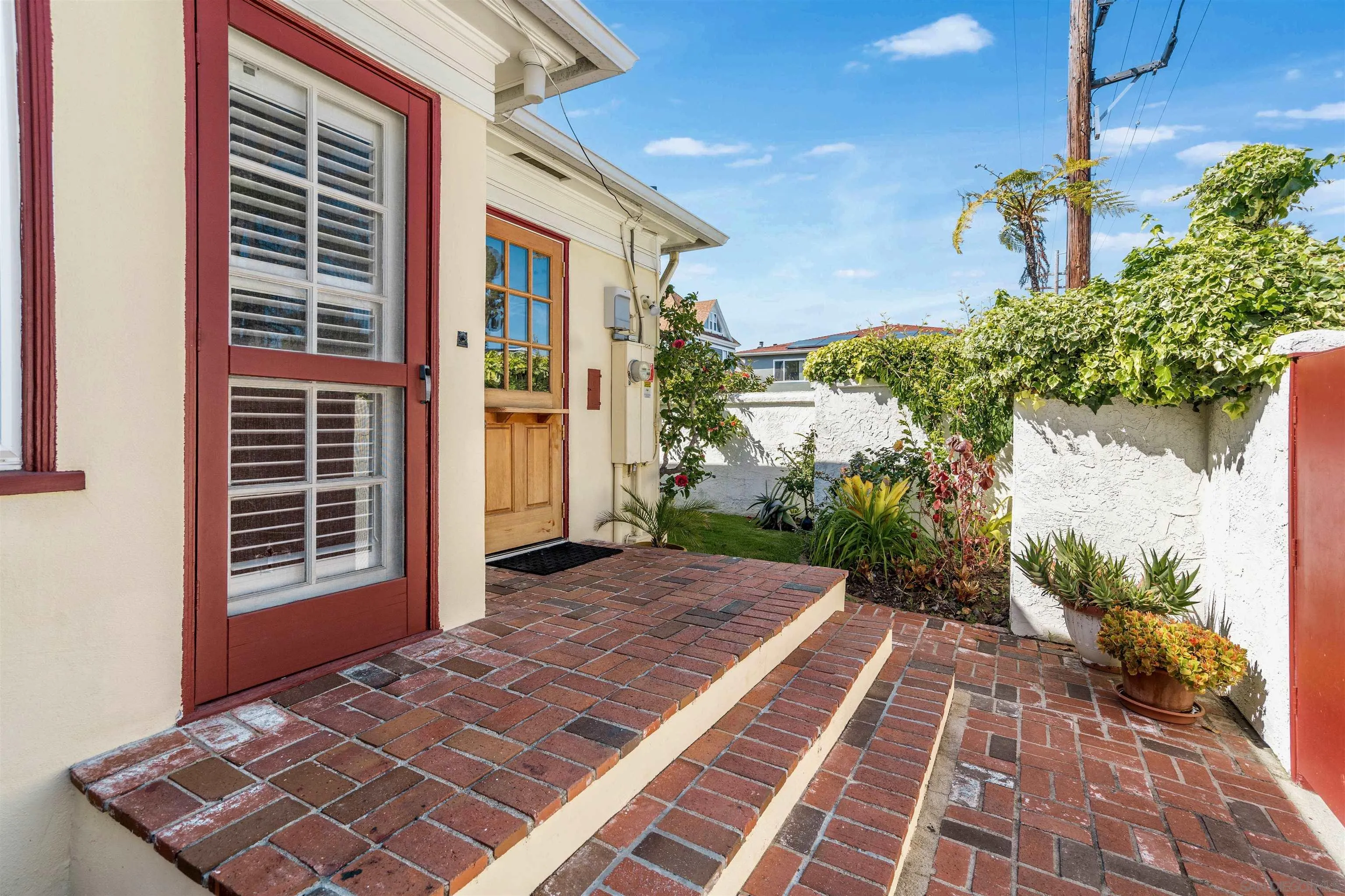1210 Third Street Coronado, CA 92118 - Photo 25 of 40 a view of a backyard with plants and a porch