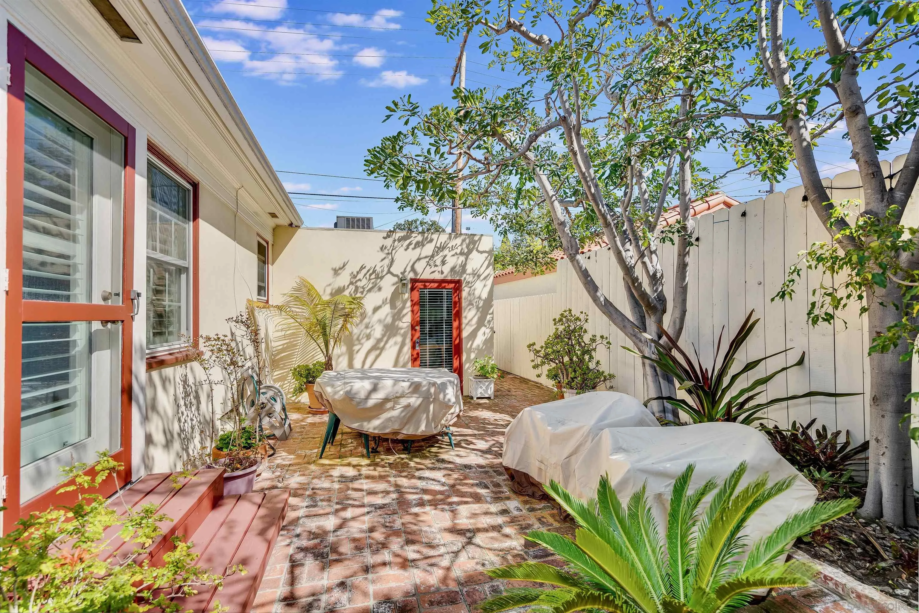 1210 Third Street Coronado, CA 92118 - Photo 28 of 40 a view of a backyard with plants and large trees