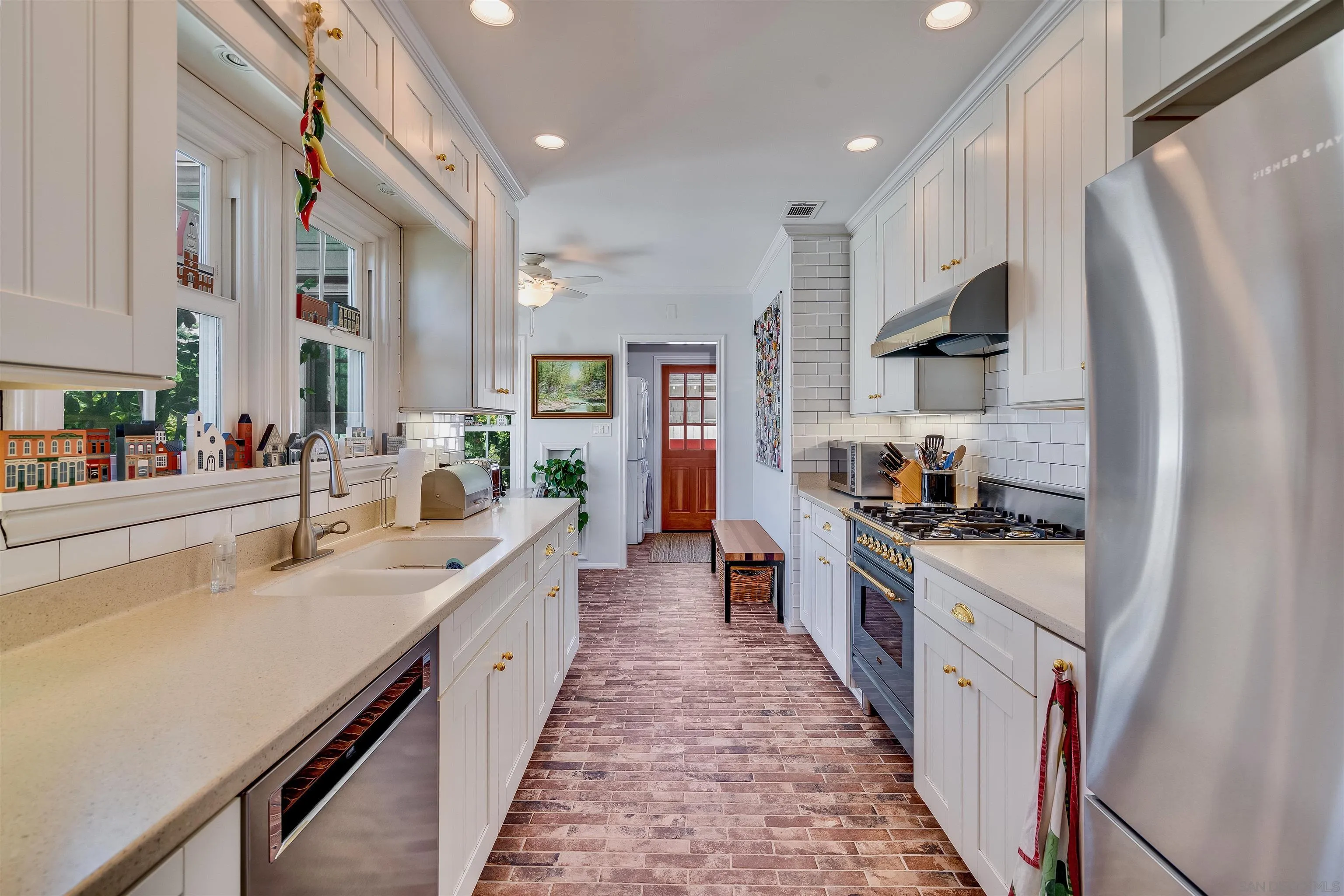 1210 Third Street Coronado, CA 92118 - Photo 10 of 40 a large kitchen with stainless steel appliances a sink stove and refrigerator