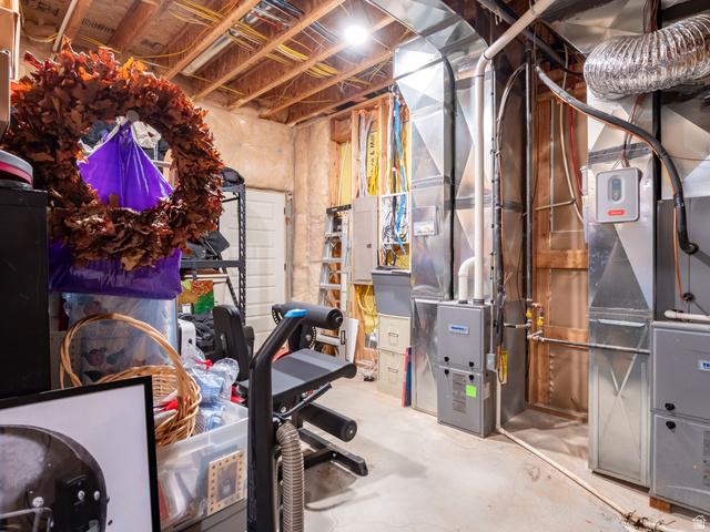 641 West 500 South Midway, UT 84049 - Photo 45 of 52 Basement mechanical room featuring exposed ductwork, a water heater, furnace units, and a concrete floor