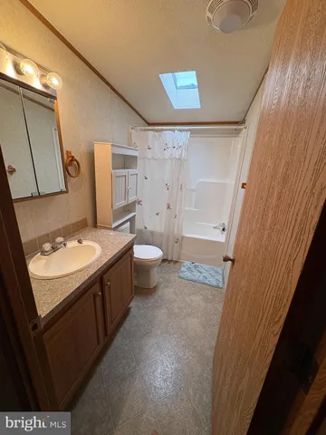 a view of a room with gym equipment and a window