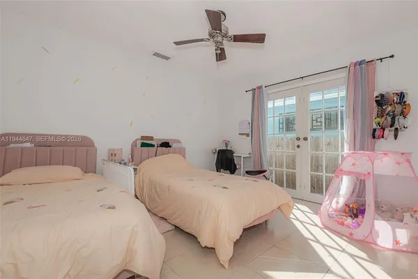 a bedroom with a bed and a painting on the wall