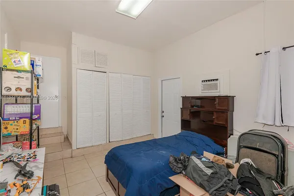 a bedroom with a bed and dresser
