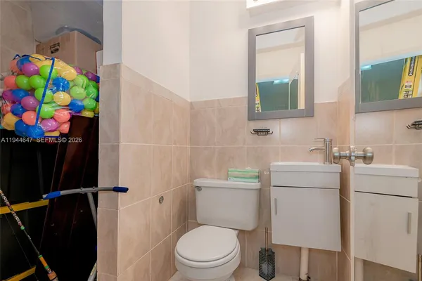 a bathroom with a sink toilet vanity and tub