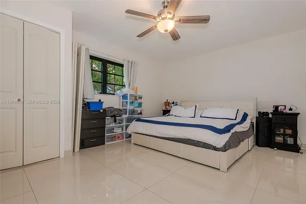 a spacious bedroom with a bed and window