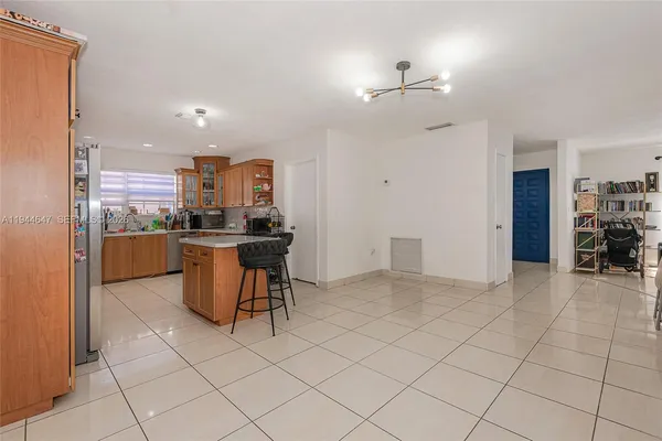 a kitchen with stainless steel appliances a refrigerator and a stove top oven