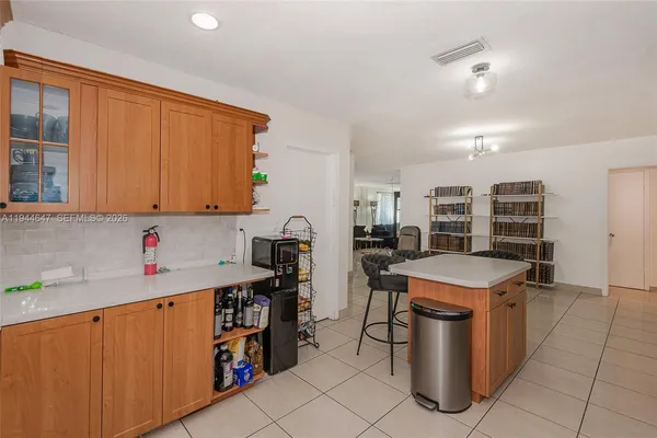 a kitchen with stainless steel appliances a stove a sink a counter top space and cabinets