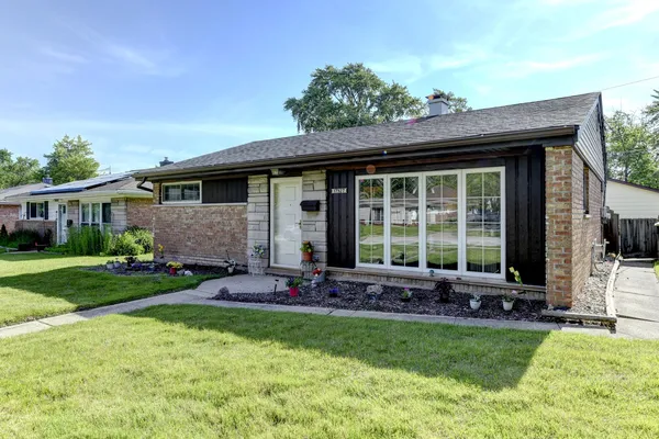 a front view of house with yard and outdoor seating