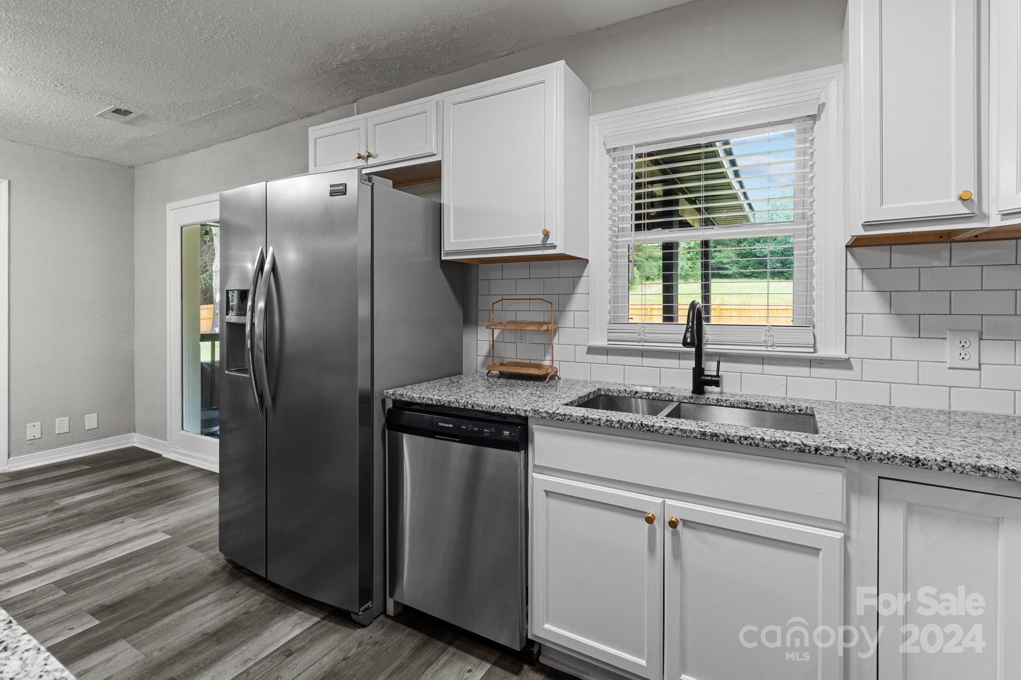 955 Lakeview Road Salisbury, NC 28147 - Photo 11 of 35 a kitchen with granite countertop a refrigerator and a sink