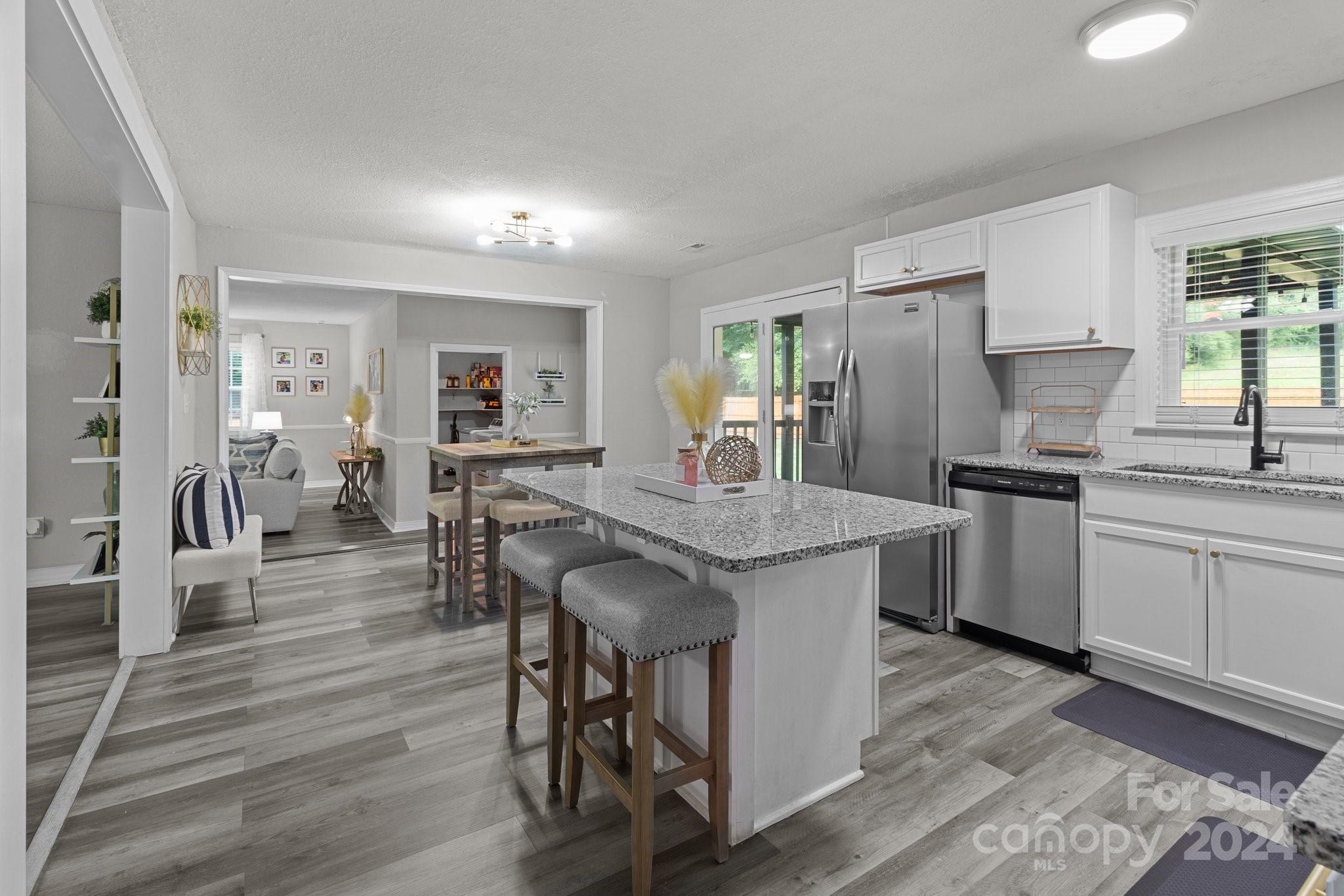 955 Lakeview Road Salisbury, NC 28147 - Photo 12 of 35 a kitchen with a table chairs refrigerator and microwave