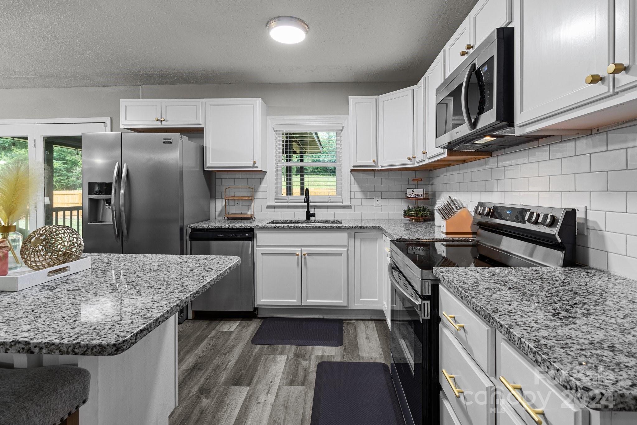 955 Lakeview Road Salisbury, NC 28147 - Photo 13 of 35 a kitchen with stainless steel appliances granite countertop a sink stove and refrigerator
