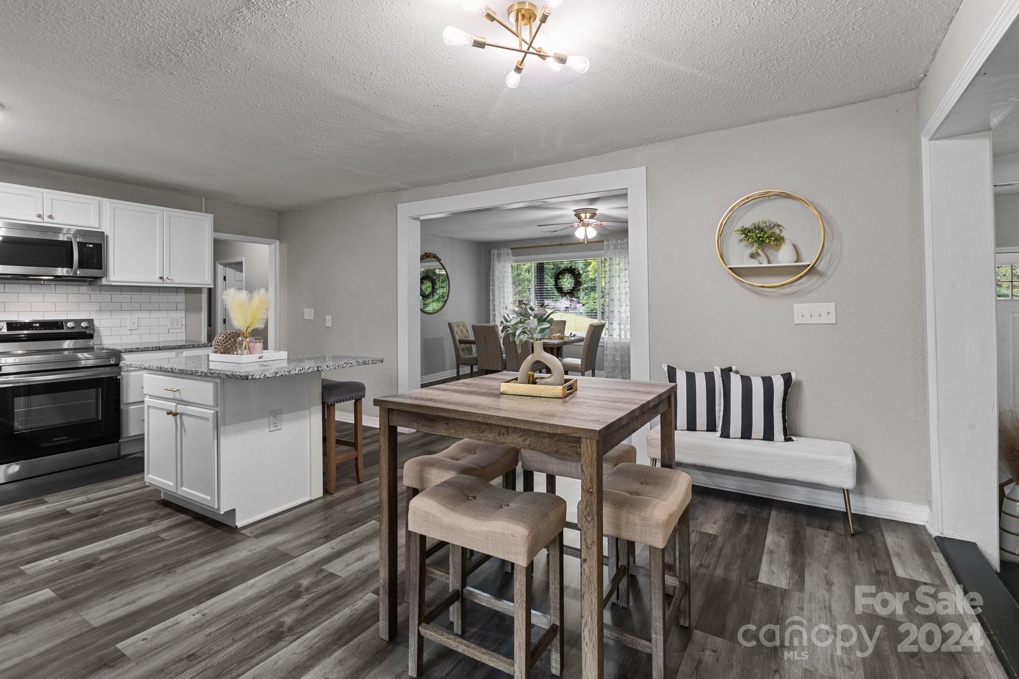 955 Lakeview Road Salisbury, NC 28147 - Photo 14 of 35 a kitchen with a table chairs and a refrigerator