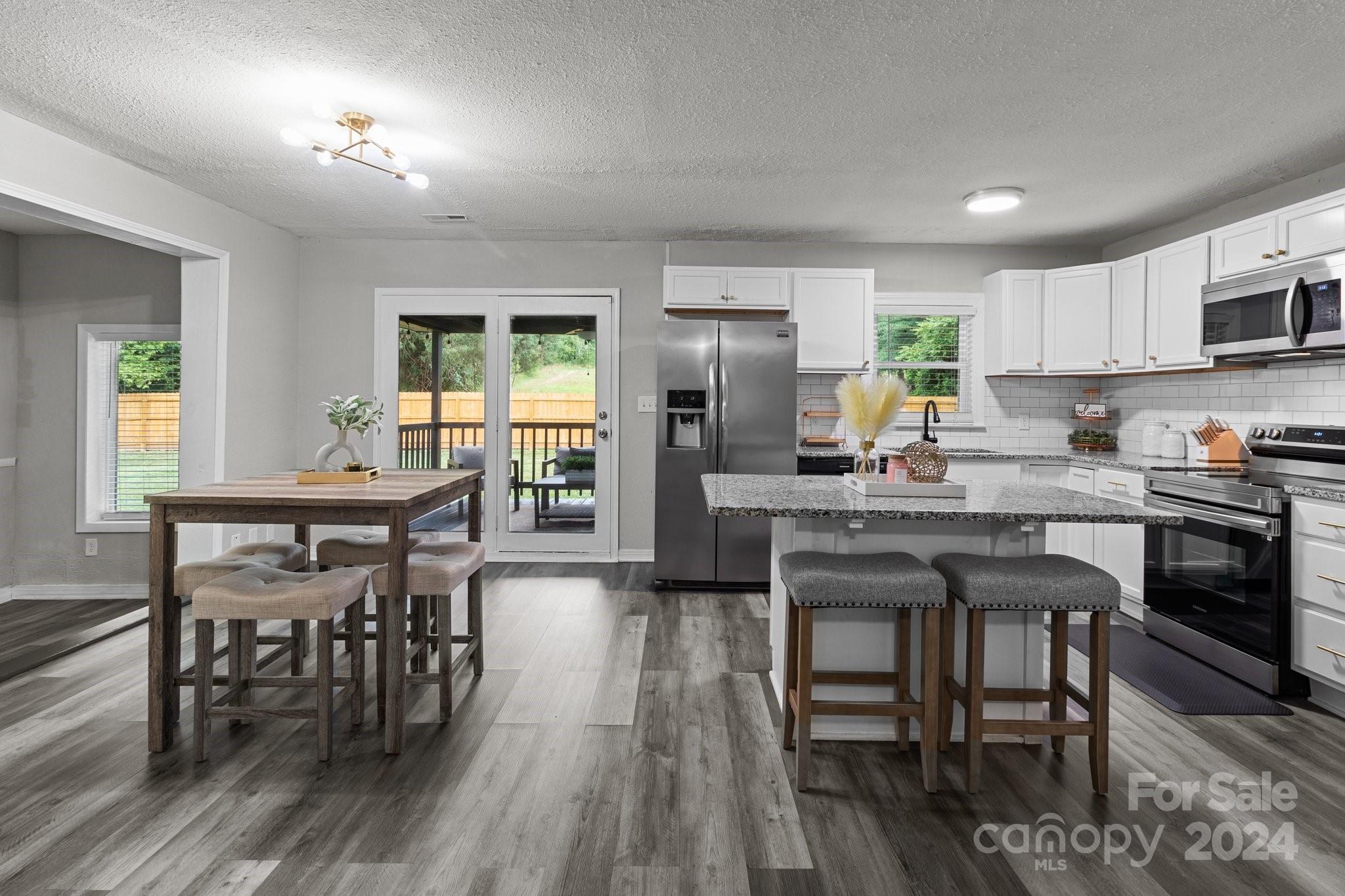 955 Lakeview Road Salisbury, NC 28147 - Photo 17 of 35 a kitchen with a table chairs refrigerator and cabinets