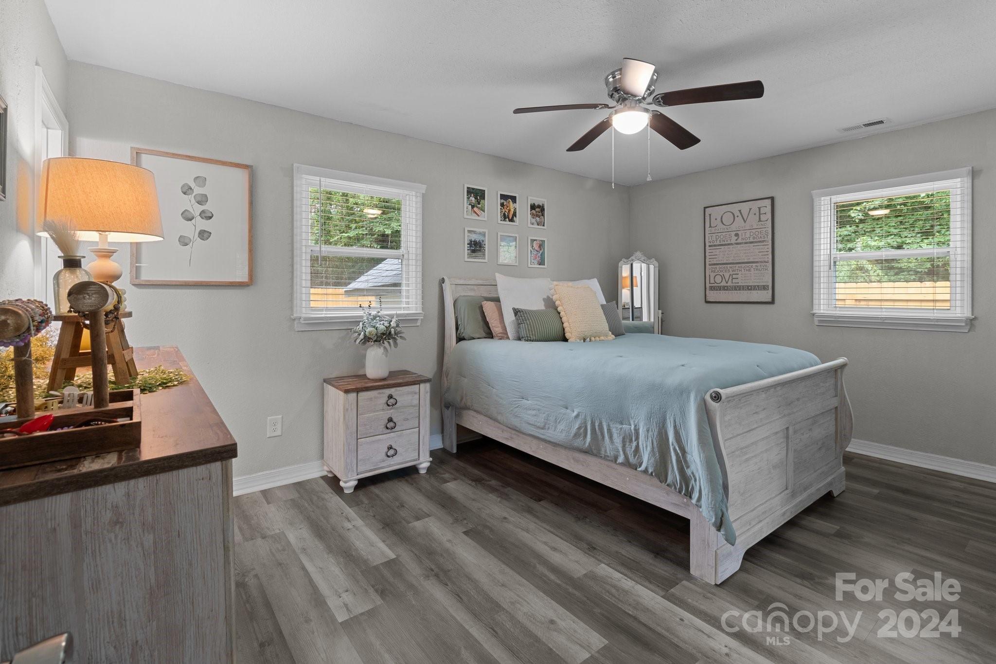 955 Lakeview Road Salisbury, NC 28147 - Photo 21 of 35 a bedroom with a large bed and a chandelier