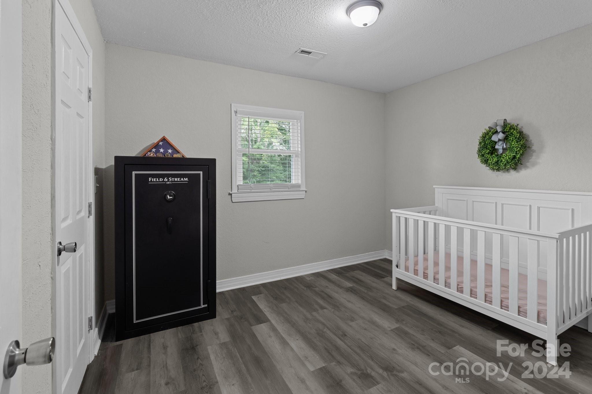 955 Lakeview Road Salisbury, NC 28147 - Photo 28 of 35 a view of a bedroom with wooden floor stairs and a window