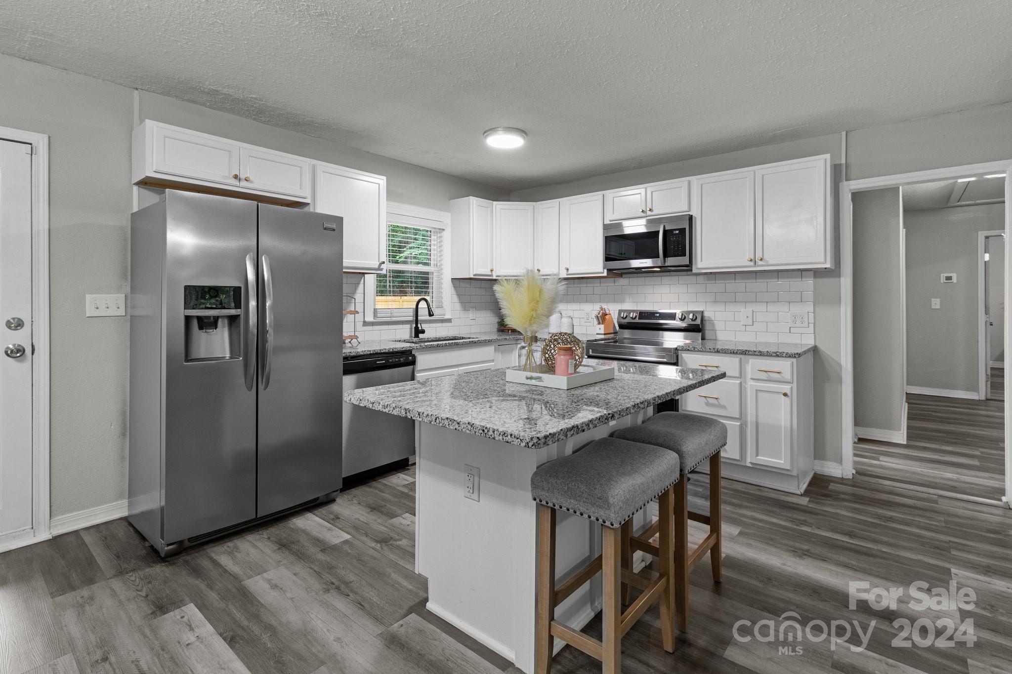 955 Lakeview Road Salisbury, NC 28147 - Photo 7 of 35 a kitchen with a refrigerator a sink a stove a microwave and cabinets