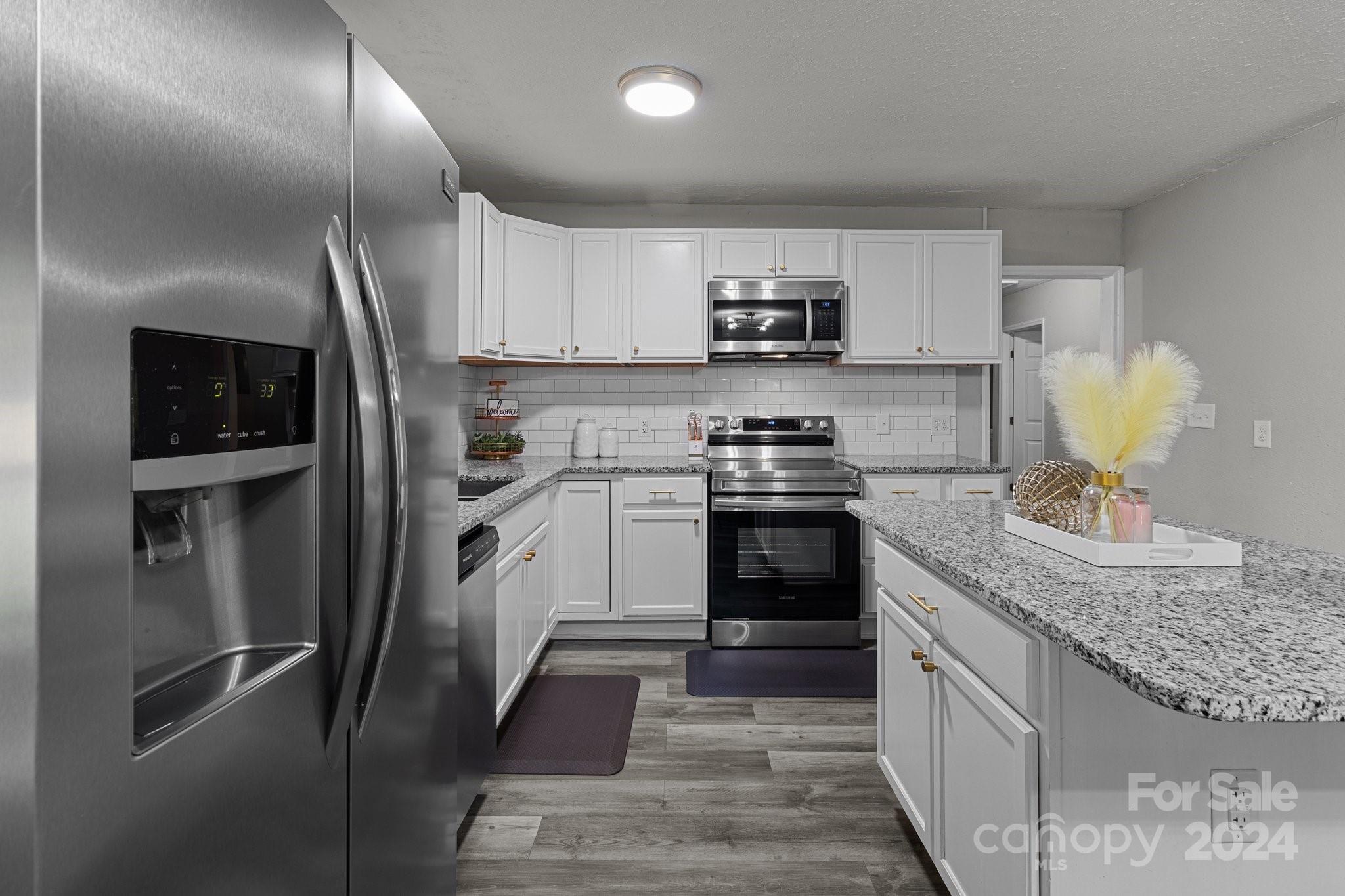 955 Lakeview Road Salisbury, NC 28147 - Photo 8 of 35 a kitchen with stainless steel appliances granite countertop a refrigerator a stove and a sink
