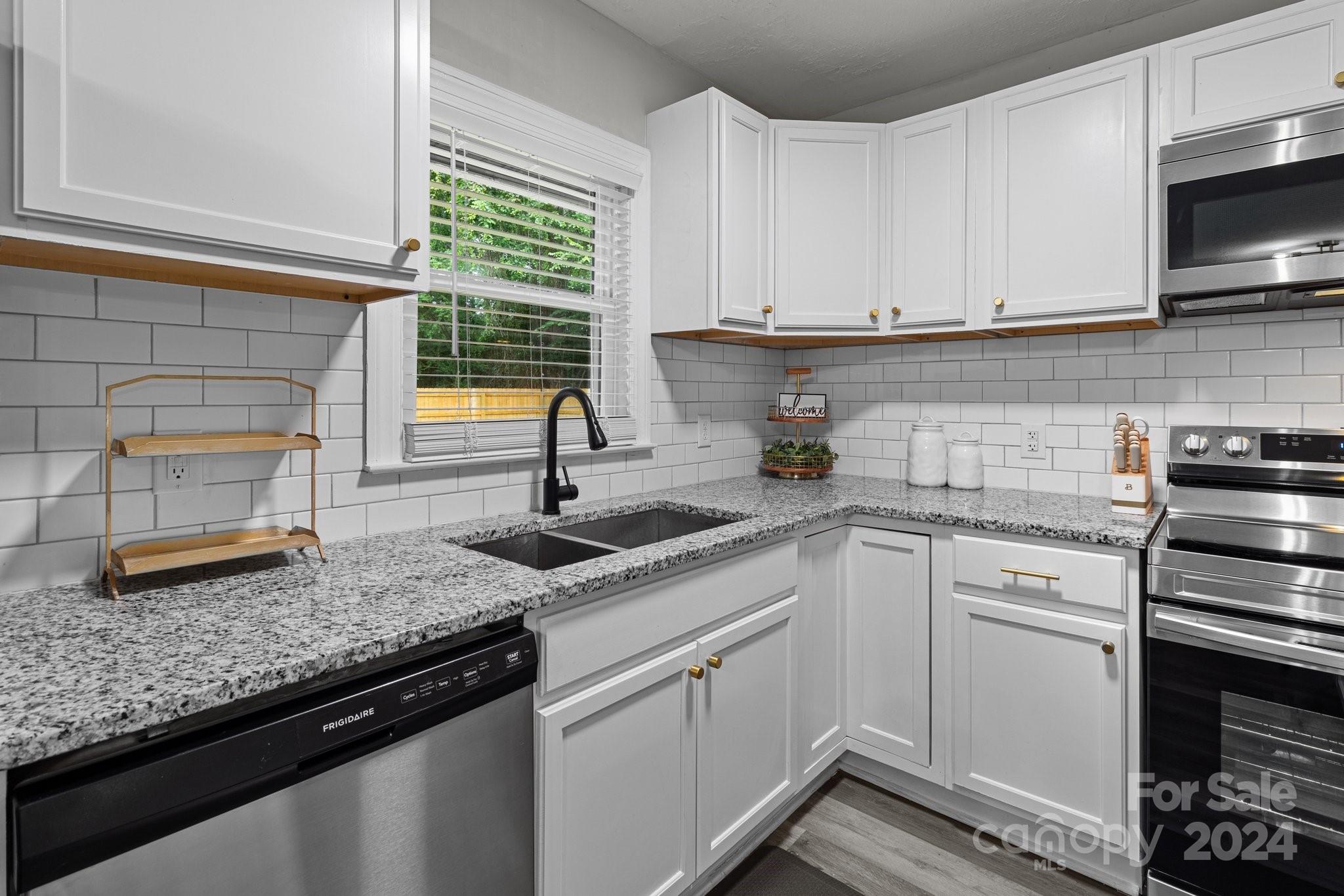 955 Lakeview Road Salisbury, NC 28147 - Photo 10 of 35 a kitchen with granite countertop a sink stainless steel appliances and cabinets