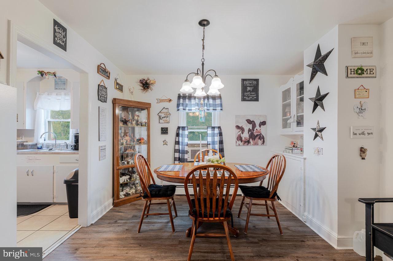 257 Center Street Timberville, VA 22853 - Photo 11 of 73 a view of a dining room with furniture window and wooden floor