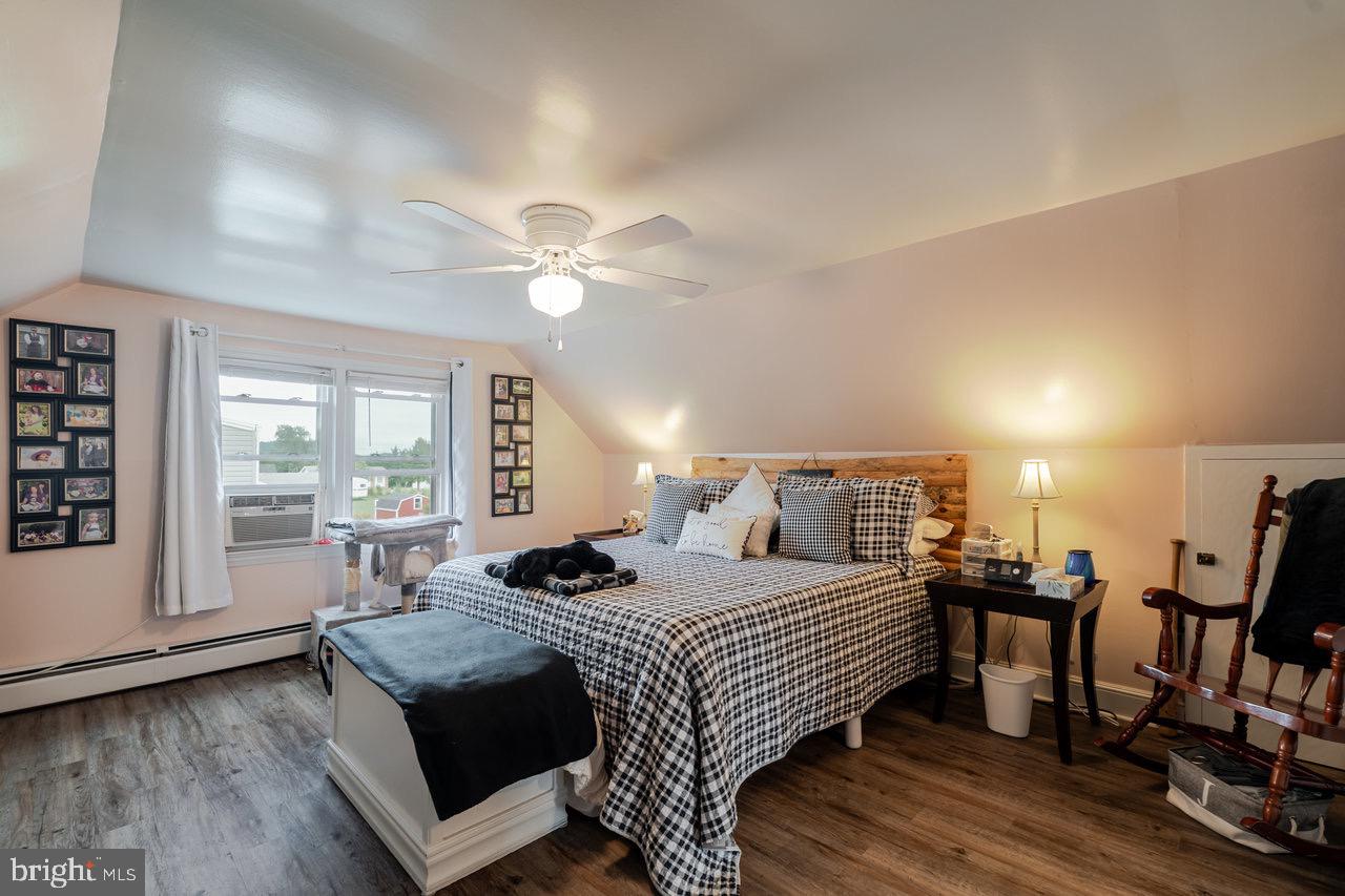 257 Center Street Timberville, VA 22853 - Photo 13 of 73 a bedroom with a bed and a large mirror with wooden floor