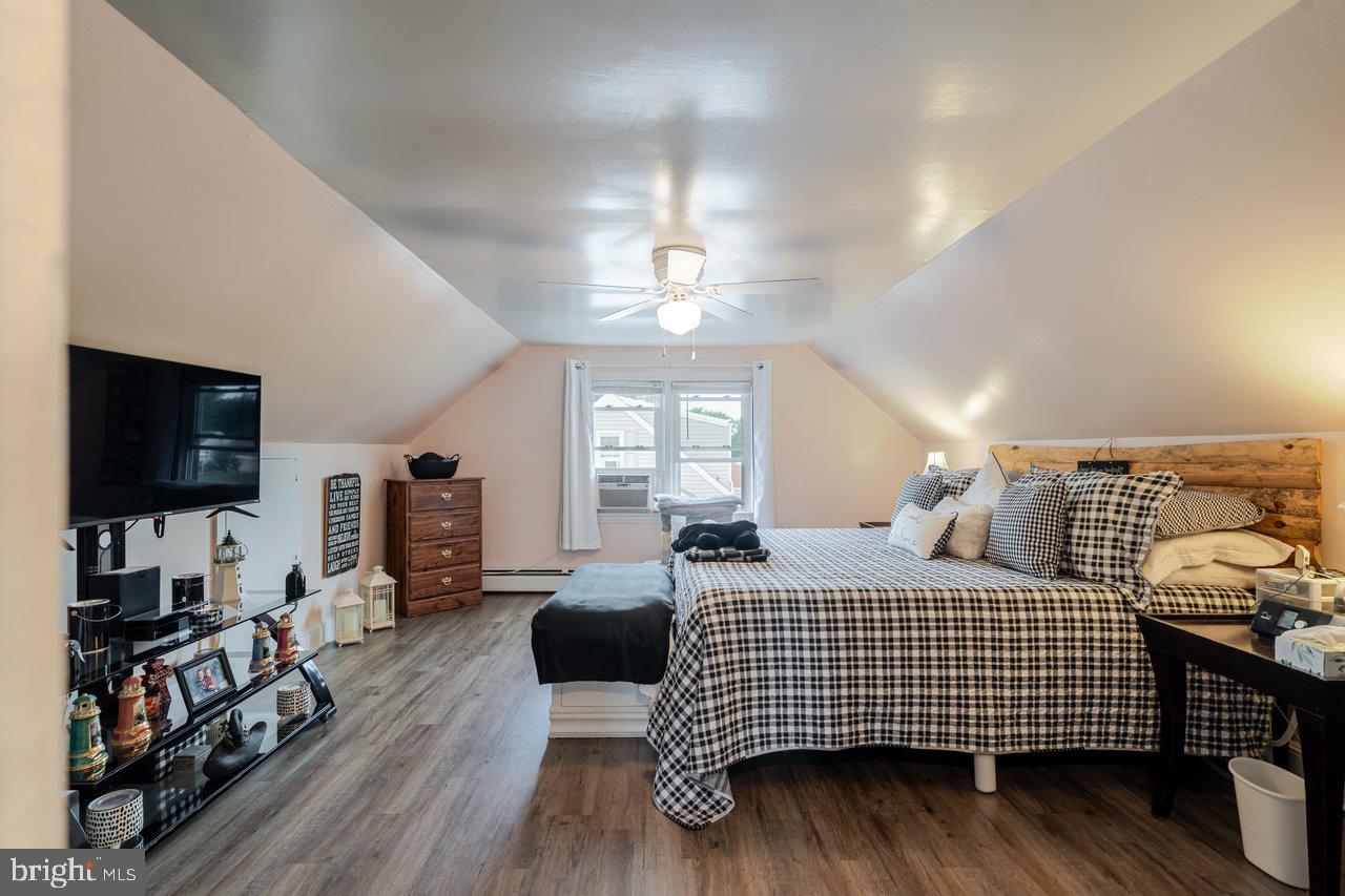 257 Center Street Timberville, VA 22853 - Photo 14 of 73 a bedroom with a bed and wooden floor