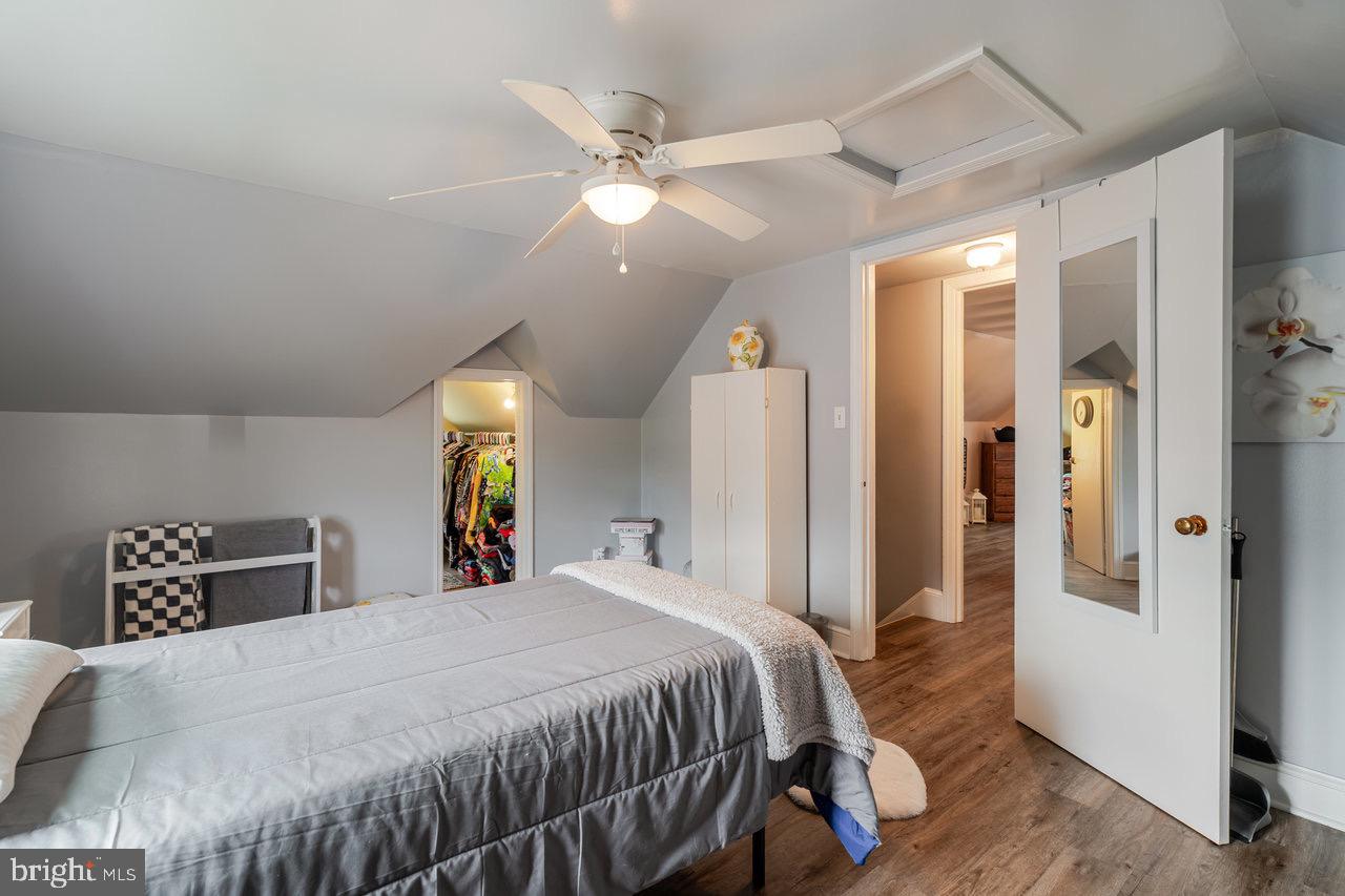 257 Center Street Timberville, VA 22853 - Photo 15 of 73 a bed sitting in a bedroom and a chandelier