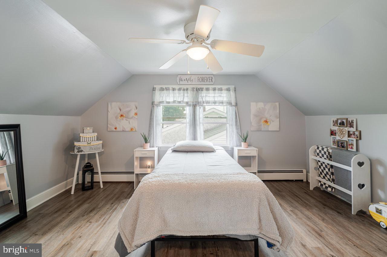 257 Center Street Timberville, VA 22853 - Photo 16 of 73 a bedroom with a bed and a chandelier