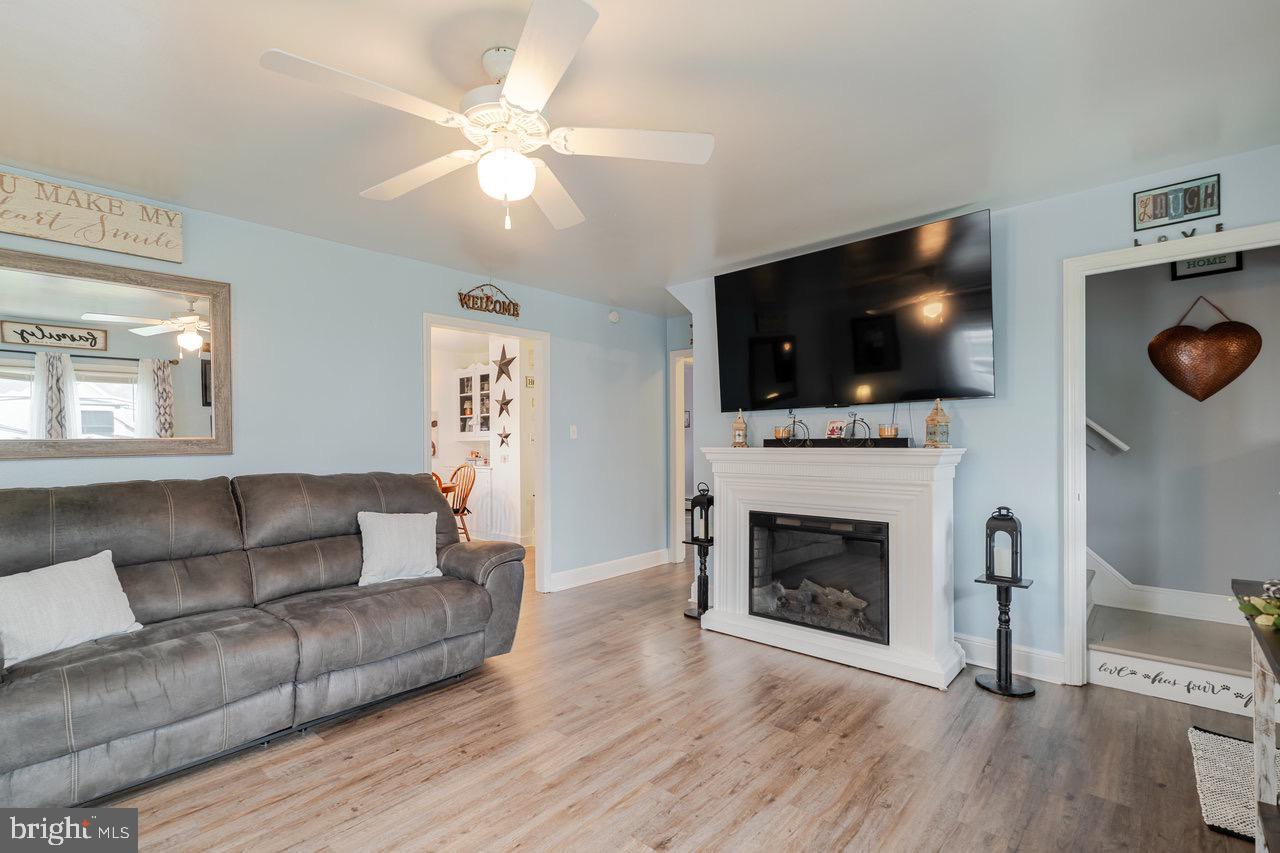 257 Center Street Timberville, VA 22853 - Photo 20 of 73 a living room with furniture a fireplace and a flat screen tv