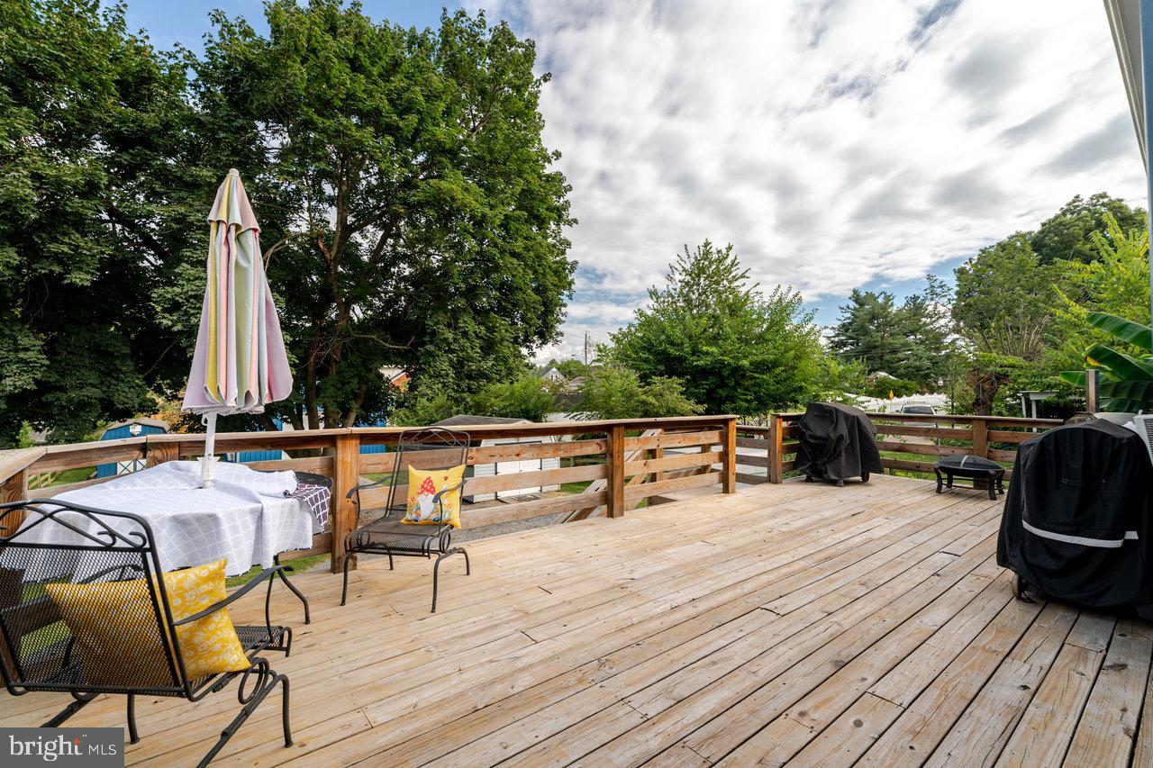 257 Center Street Timberville, VA 22853 - Photo 51 of 73 a view of roof deck with table and chairs a barbeque with wooden floor and fence