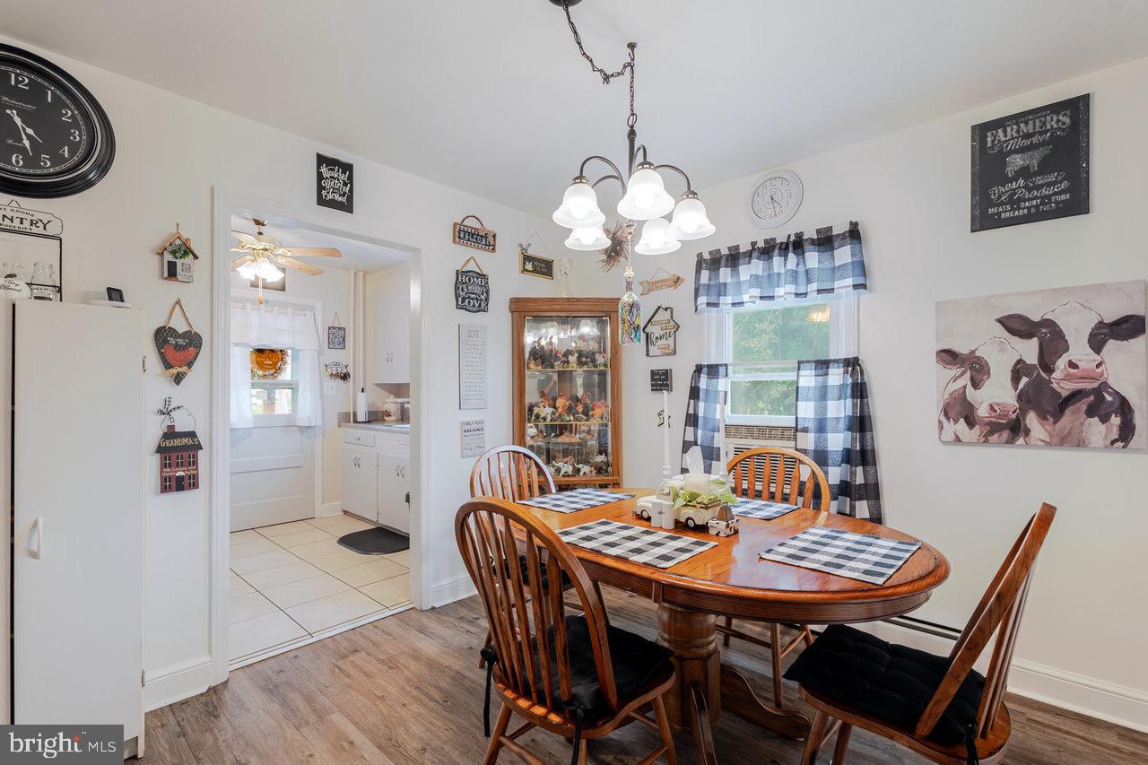 257 Center Street Timberville, VA 22853 - Photo 7 of 73 a view of a dining room with furniture large window and wooden floor