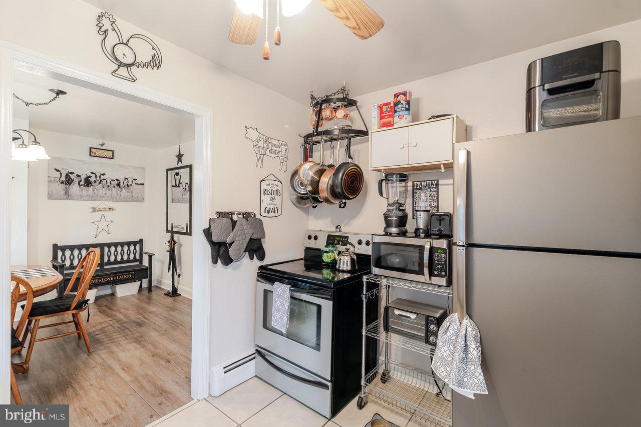 257 Center Street Timberville, VA 22853 - Photo 8 of 73 a kitchen with stainless steel appliances granite countertop a refrigerator and a stove top oven