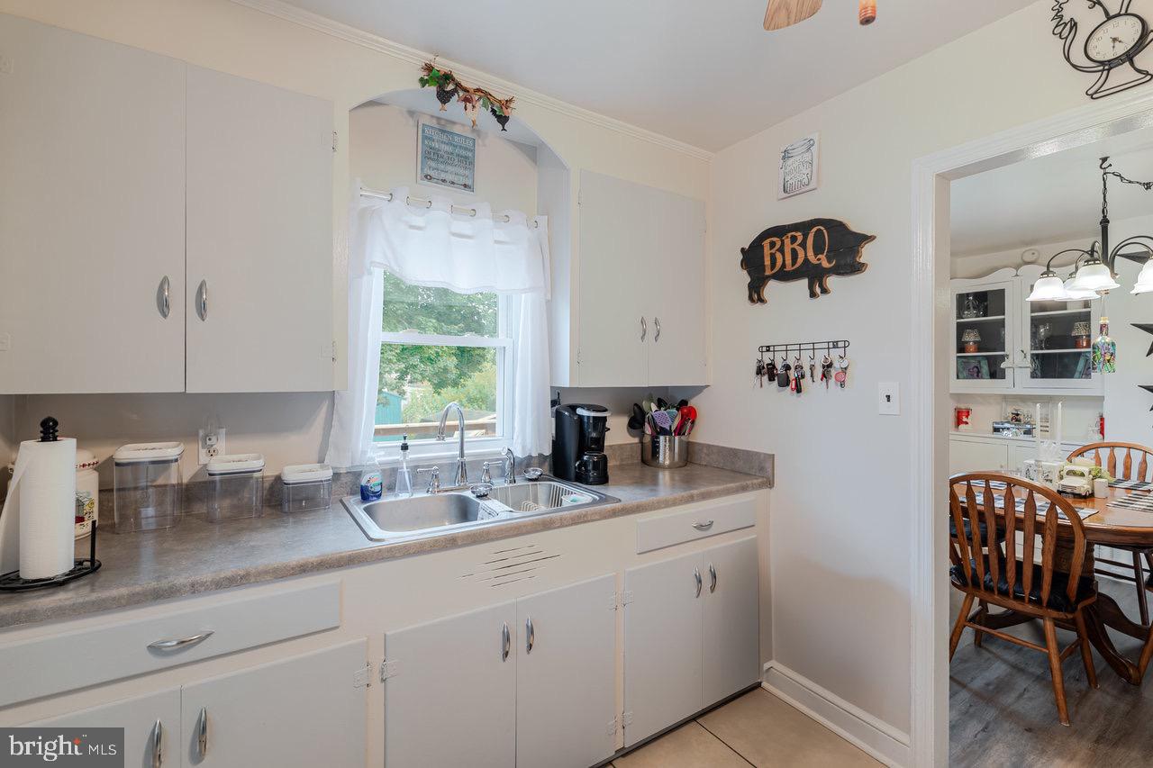 257 Center Street Timberville, VA 22853 - Photo 9 of 73 a kitchen with stainless steel appliances a sink a window and white cabinets