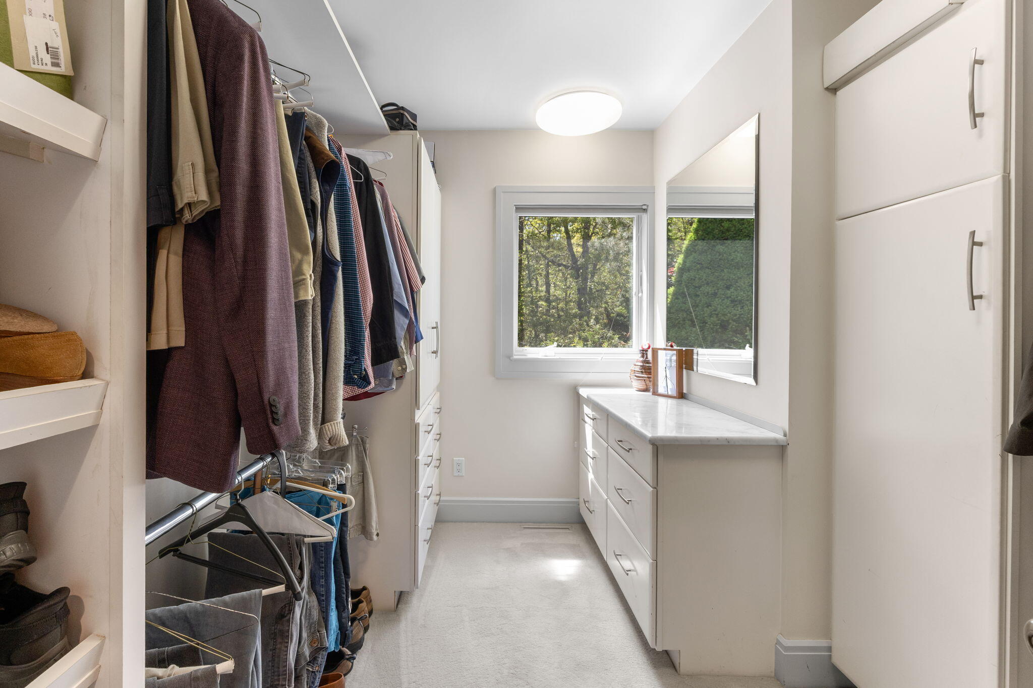 476 Baxter Neck Road Marstons Mills, MA 02648 - Photo 35 of 95 a view of walk in closet with clothes and shoes