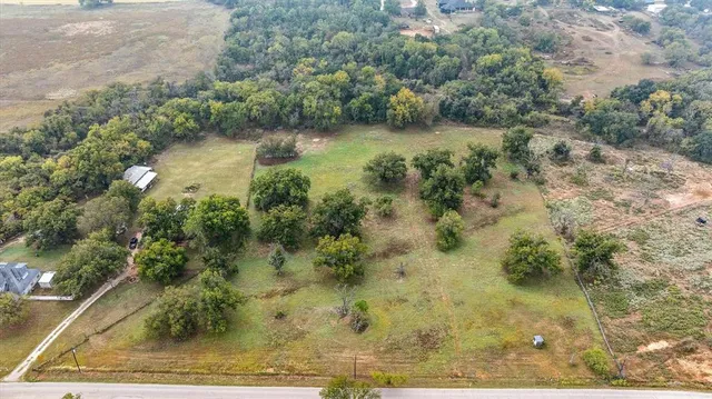 an aerial view of residential houses with outdoor space and river