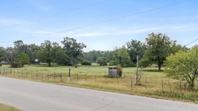 a view of outdoor space with trees all around