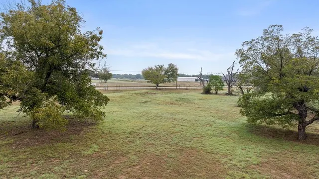 a view of yard with swimming pool and green space